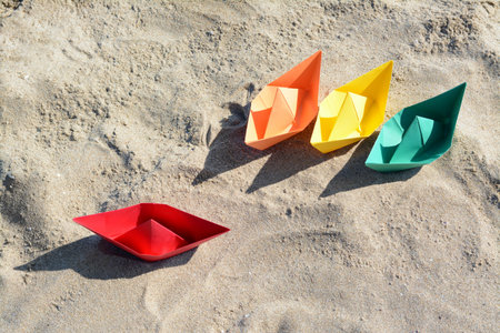 Many paper boats on sandy beach, above viewの写真素材