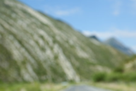 Blurred view of high mountains under sky outdoorsの写真素材