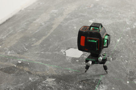 Laser level on floor, space for textの写真素材