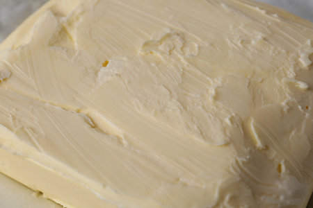 Piece of tasty homemade butter as background, closeup