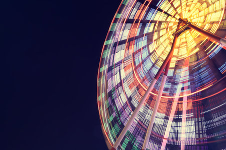 Beautiful glowing Ferris wheel against dark sky, low angle view. Space for text