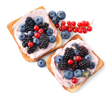 Tasty sandwiches with cream cheese and berries isolated on white, top viewの写真素材