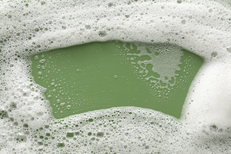 White washing foam on olive background, top viewの写真素材