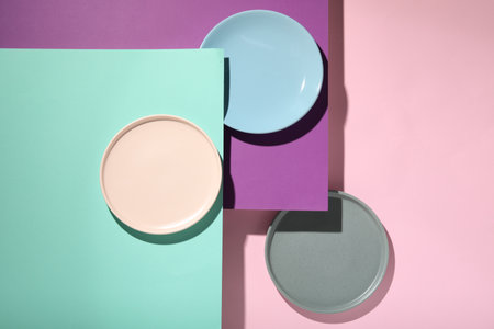 Abstract composition made of plates on color background, flat lay
