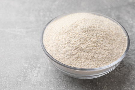 Glass bowl with quinoa flour on light gray tableの写真素材