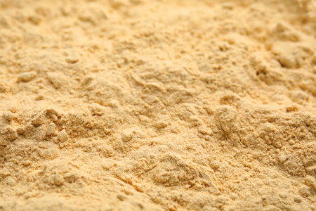 Heap of sesame flour as background, closeup viewの写真素材