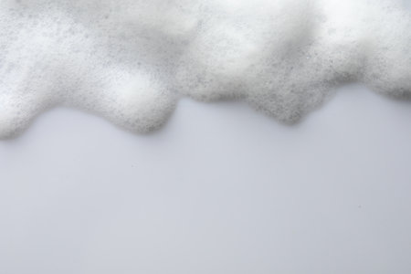 Fluffy soap foam on white background, top view