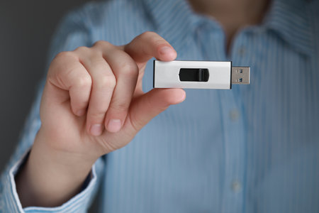 Woman holding usb flash drive, closeup viewの写真素材
