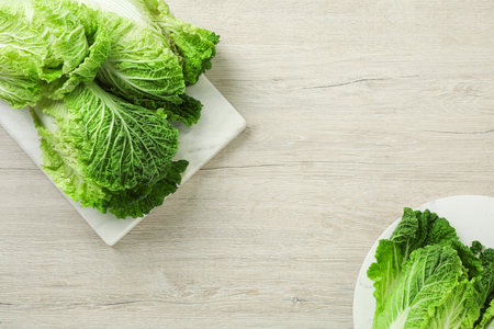 Fresh ripe Chinese cabbages on white wooden table, flat lay. Space for textの写真素材