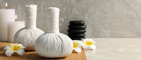 Spa bags, stones and scented candles on light gray table, space for text. banner designの写真素材