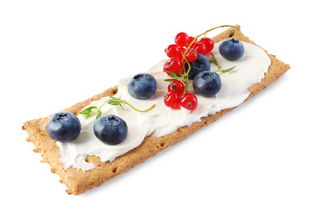 Tasty crispy cracker with cream cheese, thyme and berries isolated on whiteの写真素材