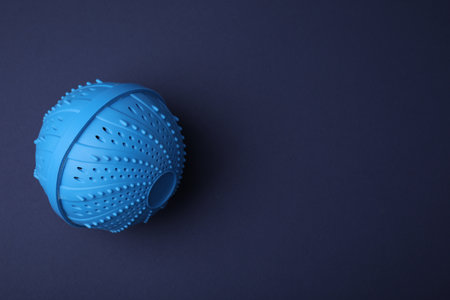 Laundry dryer ball on dark blue background, top view. Space for textの写真素材