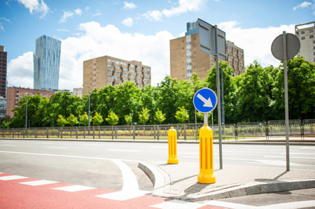 Traffic sign keep right near buildings on city streetの写真素材