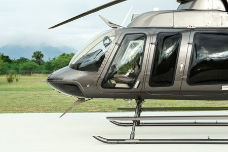 Beautiful modern helicopter on helipad in fieldの写真素材
