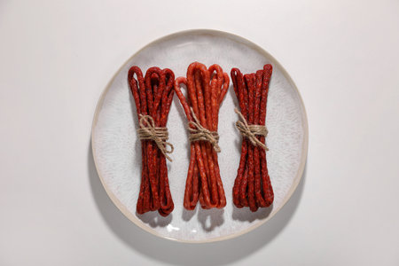 Bundles of delicious kabanosy on white background, top viewの写真素材