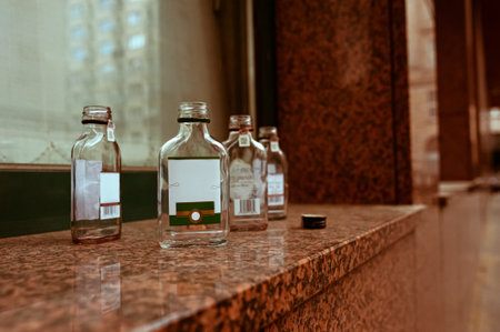 Many small glass bottles near window outdoorsの写真素材