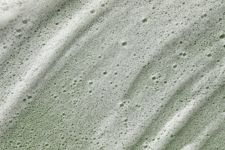 White washing foam on olive background, top viewの写真素材