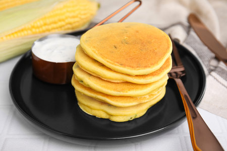 Tasty corn pancakes served on tiled table, closeupの写真素材