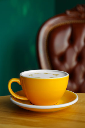 Cup of delicious coffee on wooden table indoors