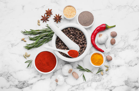 Flat lay composition with mortar and different spices on white marble tableの写真素材