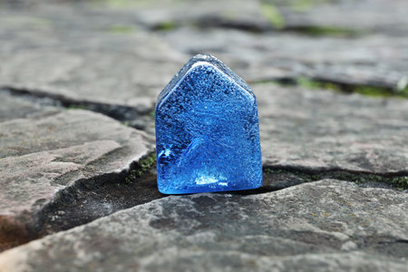 Glass house model between cracks on stone road. earthquake disasterの写真素材