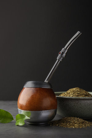 Calabash with mate tea and bombilla on light gray table