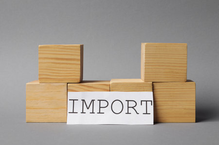 Card with word Import and wooden cubes on light gray backgroundの写真素材