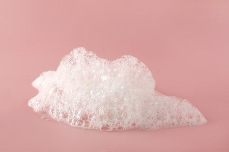 Fluffy bath foam on pink background, closeup. care productの写真素材