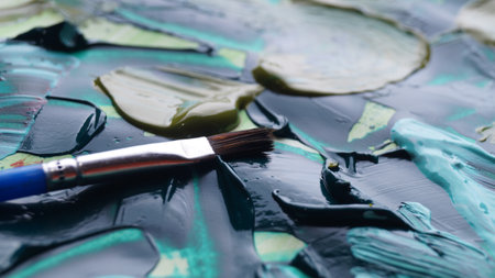 Brush on artist's palette with mixed paints, closeupの写真素材