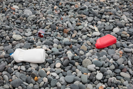 Plastic bottles thrown out on pebble coastの写真素材