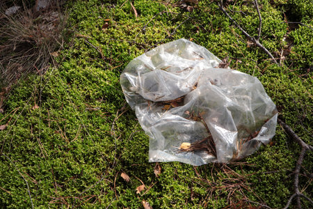 Disposable polyethylene bag on grass outdoors, top view. recycling problemの写真素材