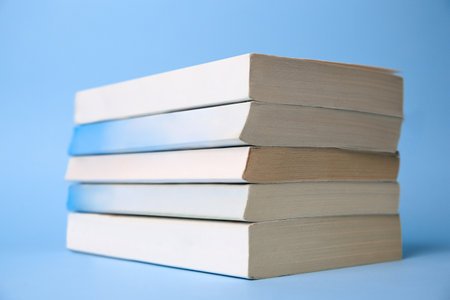 Collection of books on light blue background
