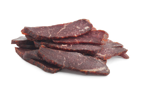 Pieces of delicious beef jerky on white backgroundの写真素材