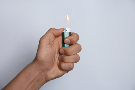 Man holding lighter on white background, closeupの写真素材