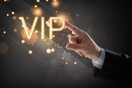 VIP member. Close up view of man pointing at virtual abbreviation on dark backgroundの写真素材