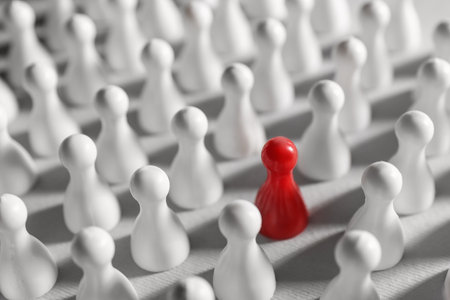 Red pawn among others on white background, closeup. Recruiter searching employeeの写真素材