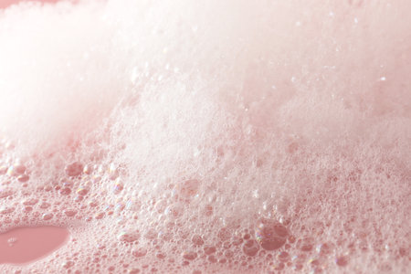 Fluffy bath foam on pink background, closeupの写真素材