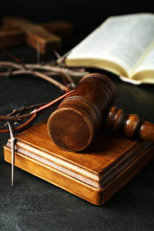 Wooden judge gavel and crown of thorns on black table, closeupの写真素材