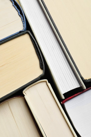 Many hardcover books as background, top view