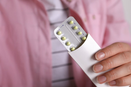 Woman holding blister of oral contraceptive pills, closeupの写真素材