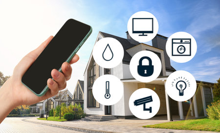 Woman using phone application for controlling smart home outdoors, closeupの写真素材