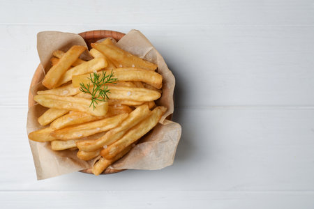 Bowl of french fries on white wooden table, top view. Space for textの写真素材
