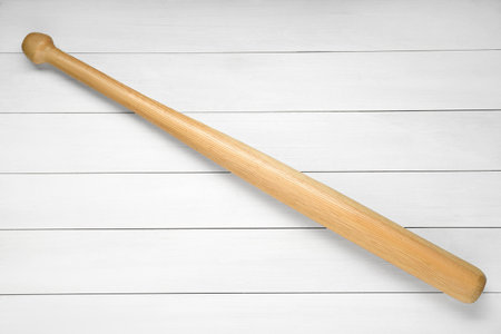 Baseball bat on white wooden table, top view. sports equipmentの写真素材