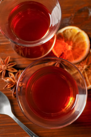 Glasses of traditional Turkish tea and ingredients on wooden table, flat layの写真素材