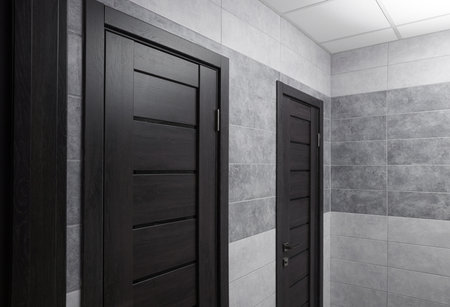 Public toilet interior with stylish doors and tilesの写真素材