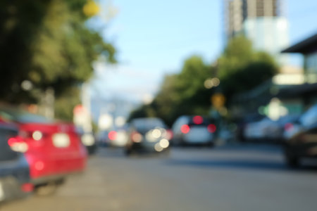 Blurred view of cityscape with cars on road. bokeh effect