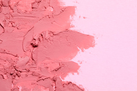 Smears of beautiful lipstick on pink background, top view. Space for textの写真素材