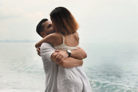 Happy young couple spending time together near the sea