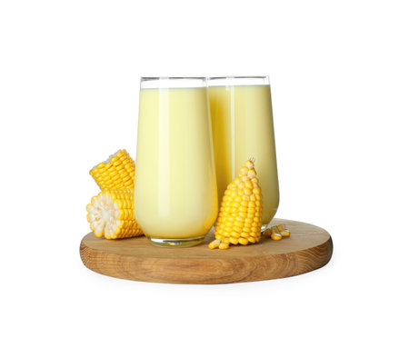 Tasty fresh corn milk in glasses and cobs on white backgroundの写真素材