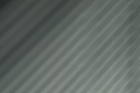 Abstract stripes made of shadows on white wallの写真素材